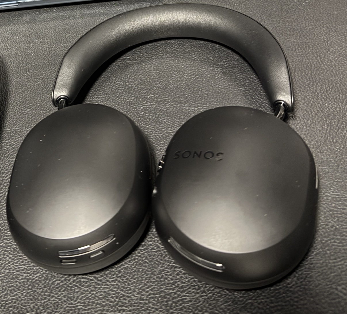 Sonos Ace black headphones, outside shot showing the SONOS logo on the earcup